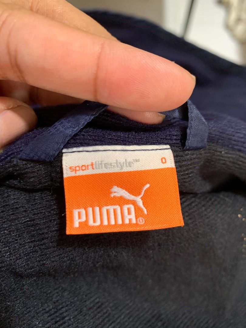 Puma Navy Blue Hooded Jacket (Category: Coats, Jackets and Outerwear) located in Lapu Lapu. Submitted by donsky14 (Listing ID 1470757241, Image 2). Description: - Brand/Model: Puma Sportlifestyle hooded jacket - Color: Navy blue with stylish contrast piping - Size: 0 (tagged on collar) - Lining: Cozy fleece lining for extra comfort - Closure: Full zip front - Material: Lightweight outer shell - Ideal for: Easy everyday athletic layering.