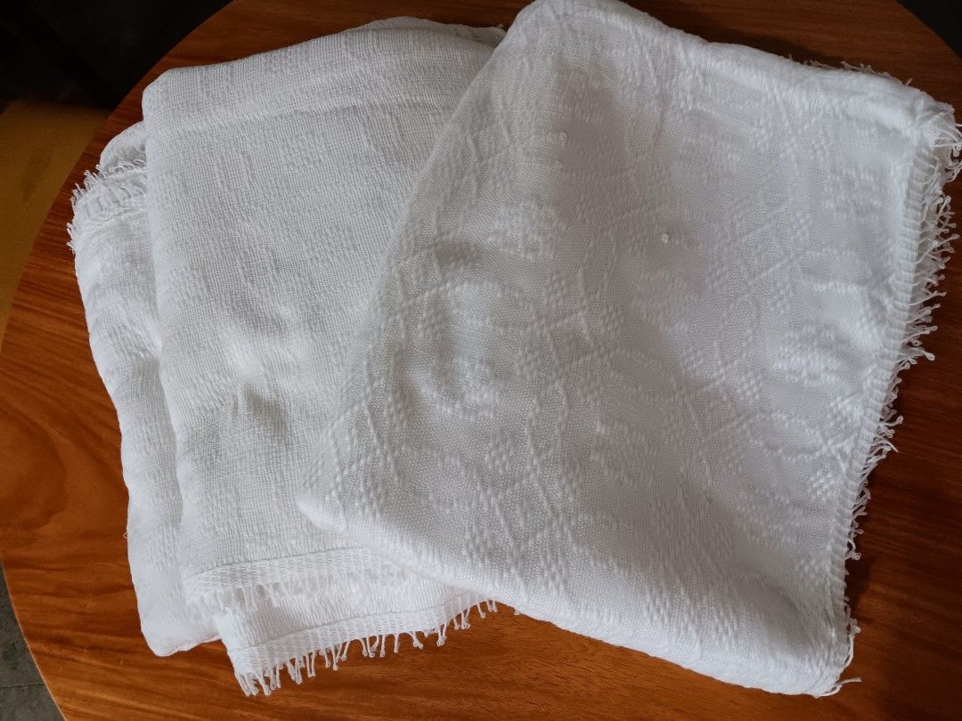 Queensize Handwoven Abel Iloco Blankets (Category: Bedding & Towels) located in Quezon City. Submitted by ViganCasaAbelIloco (Listing ID 1470774503, Image 2). Description: - Handwoven pure white textile crafted by skilled Ilocano women from Ilocos - Features traditional woven patterns and delicate fringe edges - Showcases authentic Filipino textile heritage - Add 100Php for a charming natural woven basket box tied with a ribbon - Includes an info