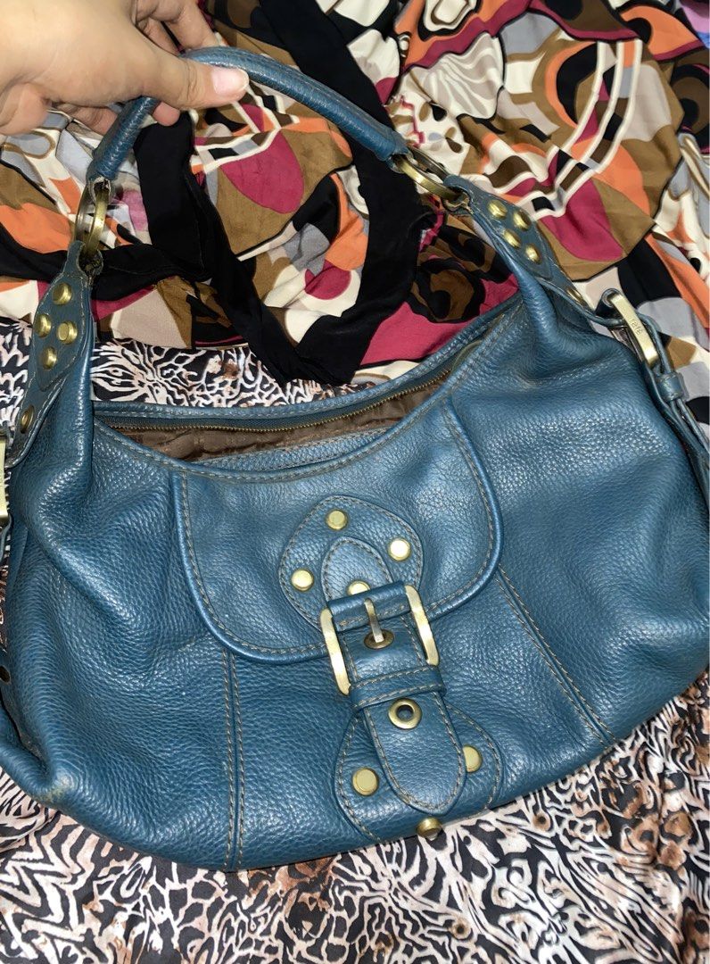 Rafe New York Blue Leather Shoulder Bag (Category: Shoulder Bags) located in Agdangan. Submitted by _freeyuh (Listing ID 1470752115, Image 1). Description: - Brand: Rafe New York - Color: Gorgeous blue leather with gold-tone hardware - Design: Front flap buckle detail and stylish contrast stitching - Interior: Brown monogram fabric lining with convenient slip pockets - Closure: Secure top zipper closure - Strap: Adjustable strap accented with met