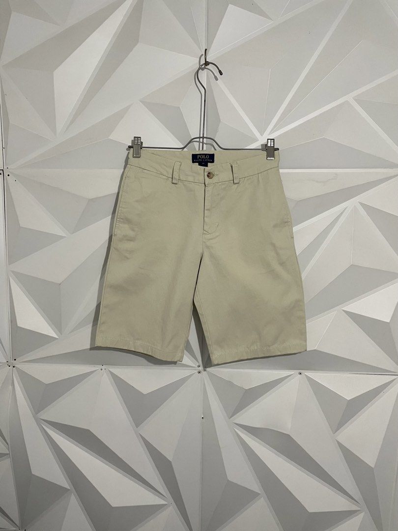 Ralph Lauren Beige Chino Shorts (Category: Shorts) located in Cabuyao City. Submitted by ParadisethriftedPh (Listing ID 1470923943, Image 3). Description: Cr: 9.5/10 Dimensions Waist: 26-28 Lenght: 18 - Brand: Polo Ralph Lauren - Color: Classic Beige - Size: 14 - Material: 100% Cotton (Made in China) - Style: Chino shorts with button closure and back pockets - Details: Signature embroidered pony logo on the back right - Condition: Clean and well-