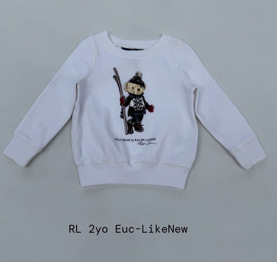 Ralph Lauren Polo Bear Ski Sweatshirt 2 Years (Category: Babies & Kids Fashion) located in Pozorrubio. Submitted by izaykite2g (Listing ID 1470760721, Image 1). Description: - Brand: Ralph Lauren - Size: 2 Years Old (Toddler) - Color: Classic White - Design: Iconic Ski Polo Bear graphic print - Material: Soft and comfortable cotton blend - Condition: Clean fabric with clear, vibrant print.