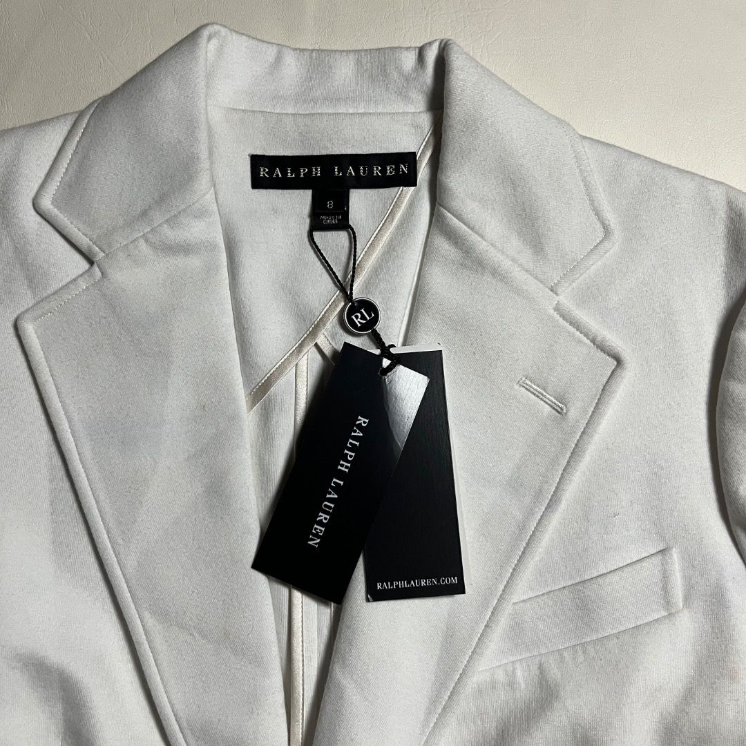 Ralph Lauren White Blazer Jacket Size 6 NWT (Category: Coats, Jackets and Outerwear) located in Caloocan City. Submitted by achilles_grails (Listing ID 1470826480, Image 3). Description: - Brand: Ralph Lauren - Condition: Brand new with original tags attached - Size: US 6 - Color: Classic White - Closure: Single front button - Pockets: Functional waist pockets - Details: Branded metallic buttons on cuffs; extra buttons included in an internal pou