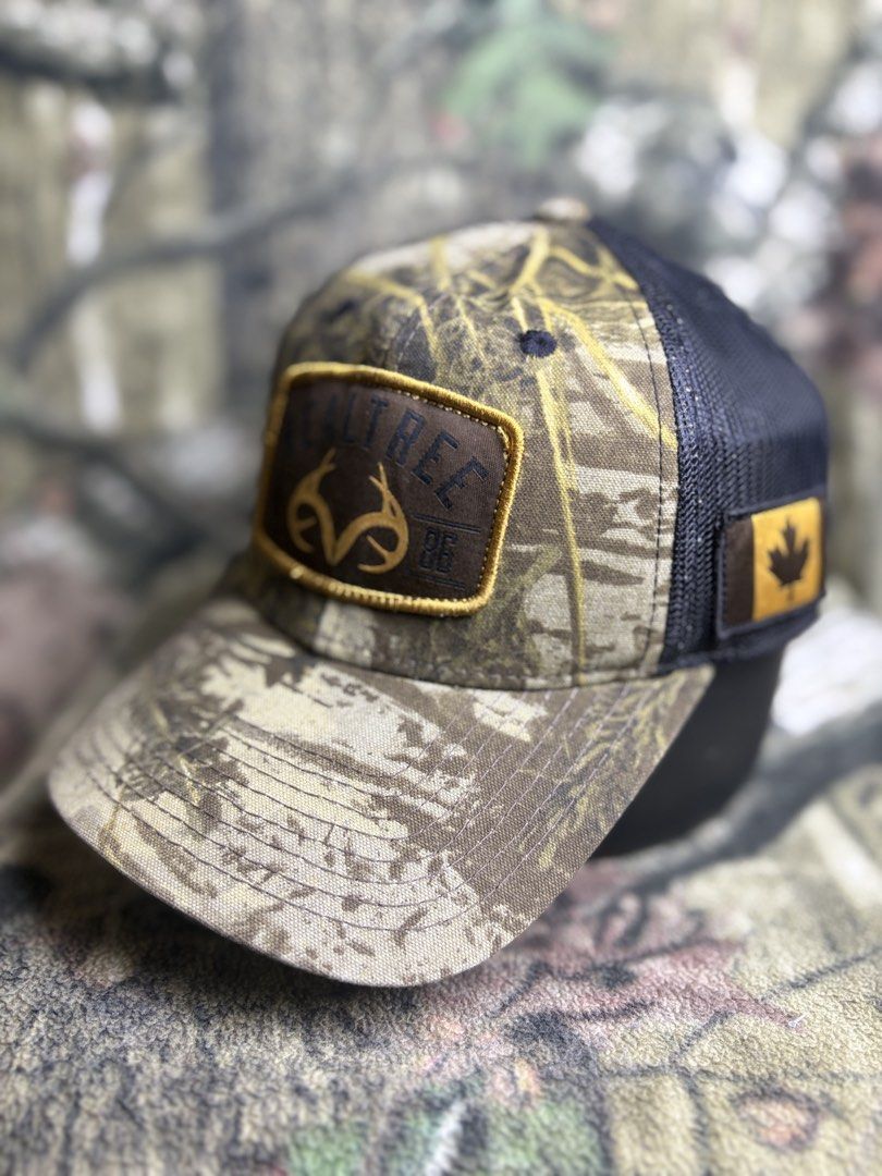 Realtree trucker Cap (Category: Caps & Hats) located in Manila. Submitted by josh2295 (Listing ID 1470757620, Image 2). Description: Realtree camo hunting and trucker-style baseball cap featuring a brown leather-look patch on the front and a Canadian flag patch on the side..