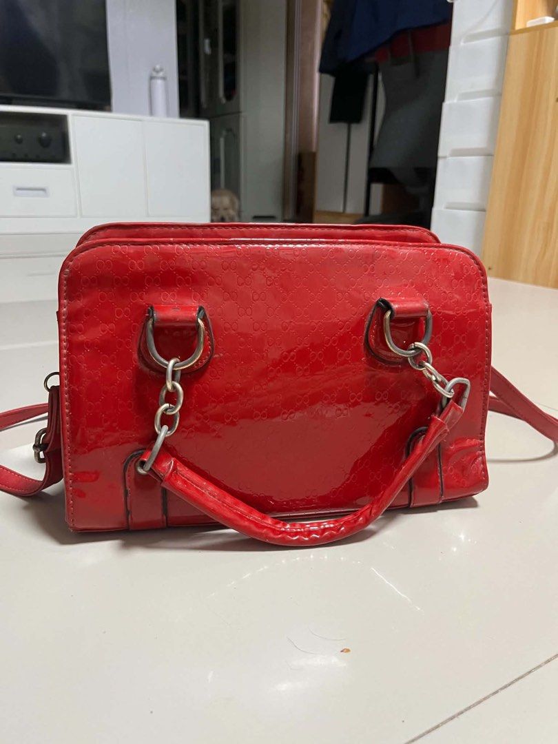 Red Patent Leather Monogram Satchel Shoulder Bag (Category: Luxury Bags & Wallets) located in Cavite. Submitted by starberrii (Listing ID 1470777231, Image 2). Description: - Color & Material: Bright red patent leather with an all-over embossed monogram pattern - Handles: Dual top handles with chic chain links - Strap: Includes a detachable matching shoulder strap - Closure: Secure zip top closure - Shape: Structured rectangular design with sleek