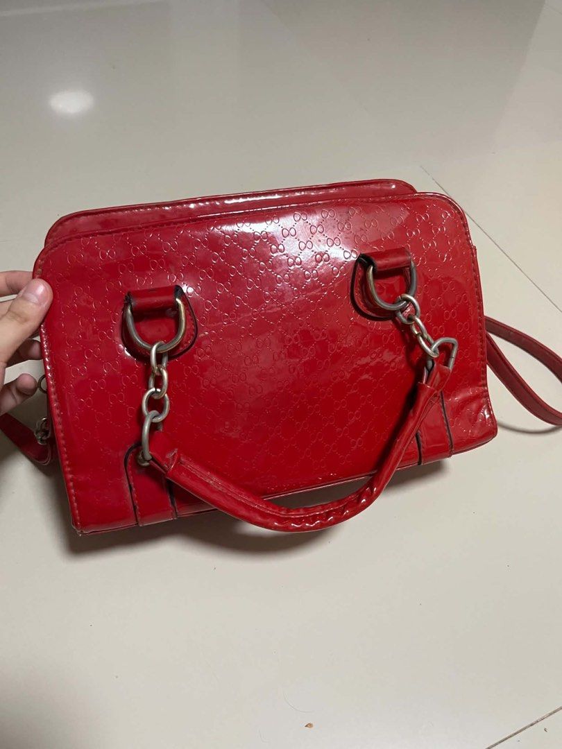 Red Patent Leather Monogram Satchel Shoulder Bag (Category: Luxury Bags & Wallets) located in Cavite. Submitted by starberrii (Listing ID 1470777231, Image 3). Description: - Color & Material: Bright red patent leather with an all-over embossed monogram pattern - Handles: Dual top handles with chic chain links - Strap: Includes a detachable matching shoulder strap - Closure: Secure zip top closure - Shape: Structured rectangular design with sleek