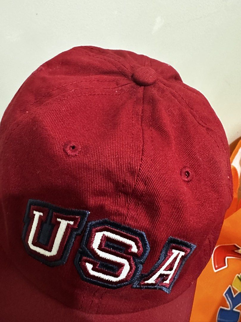 Red USA Embroidered Baseball Cap (Category: Caps & Hats) located in Balanga. Submitted by jamilbeauty5 (Listing ID 1470759209, Image 3). Description: - Classic red baseball cap with white 'USA' embroidery - Structured six-panel design with breathable eyelets - Adjustable strapback with a secure metal buckle - Clean fabric inside and out with a sturdy brim - Perfect for casual everyday wear USA EMBROIDERED KOHLS ADULT ADJUSTABLE BUCKLE BACK OSFA C