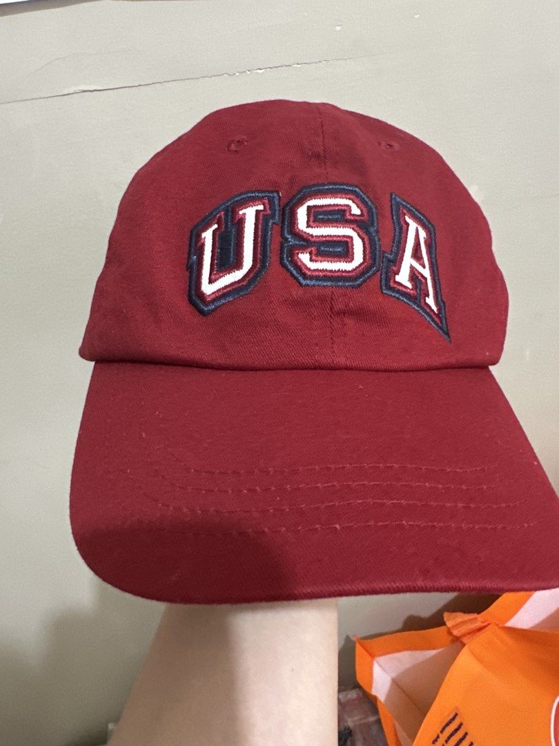 Red USA Embroidered Baseball Cap (Category: Caps & Hats) located in Balanga. Submitted by jamilbeauty5 (Listing ID 1470759209, Image 1). Description: - Classic red baseball cap with white 'USA' embroidery - Structured six-panel design with breathable eyelets - Adjustable strapback with a secure metal buckle - Clean fabric inside and out with a sturdy brim - Perfect for casual everyday wear USA EMBROIDERED KOHLS ADULT ADJUSTABLE BUCKLE BACK OSFA C