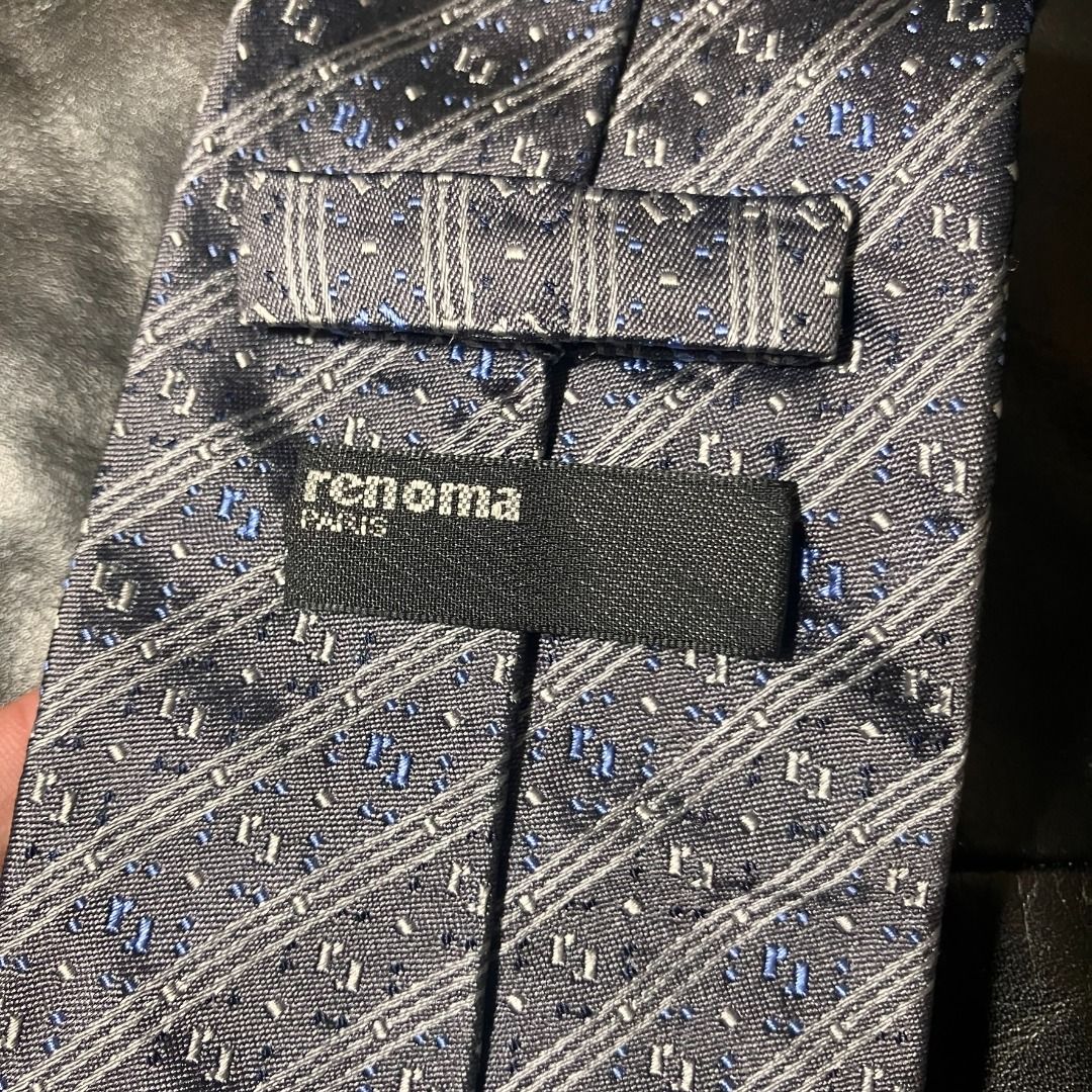 Renoma Paris 100% Silk Diagonal Stripe Necktie (Category: Ties) located in Manila. Submitted by nellyfrustrado (Listing ID 1470809937, Image 2). Description: tem Specifics: Brand: Renoma Paris (Features official brand label and matching patterned keeper loop). Material: 100% Silk (Labeled "100% SILK / 100% SOIE / 100% SETA"). Made in Italy. Colorway: Charcoal grey and slate blue base accented with diagonal woven stripes and subtle silver and roya