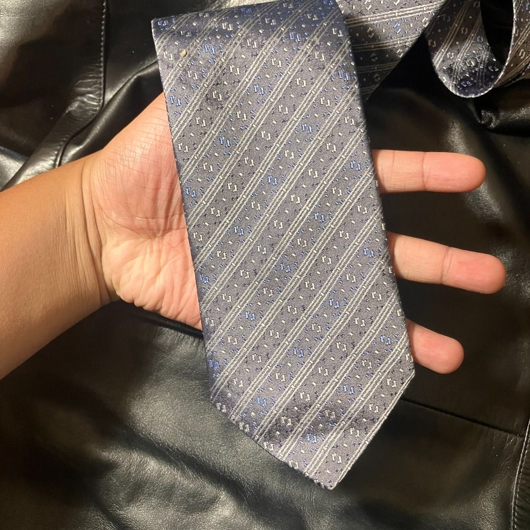 Renoma Paris 100% Silk Diagonal Stripe Necktie (Category: Ties) located in Manila. Submitted by nellyfrustrado (Listing ID 1470809937, Image 1). Description: tem Specifics: Brand: Renoma Paris (Features official brand label and matching patterned keeper loop). Material: 100% Silk (Labeled "100% SILK / 100% SOIE / 100% SETA"). Made in Italy. Colorway: Charcoal grey and slate blue base accented with diagonal woven stripes and subtle silver and roya