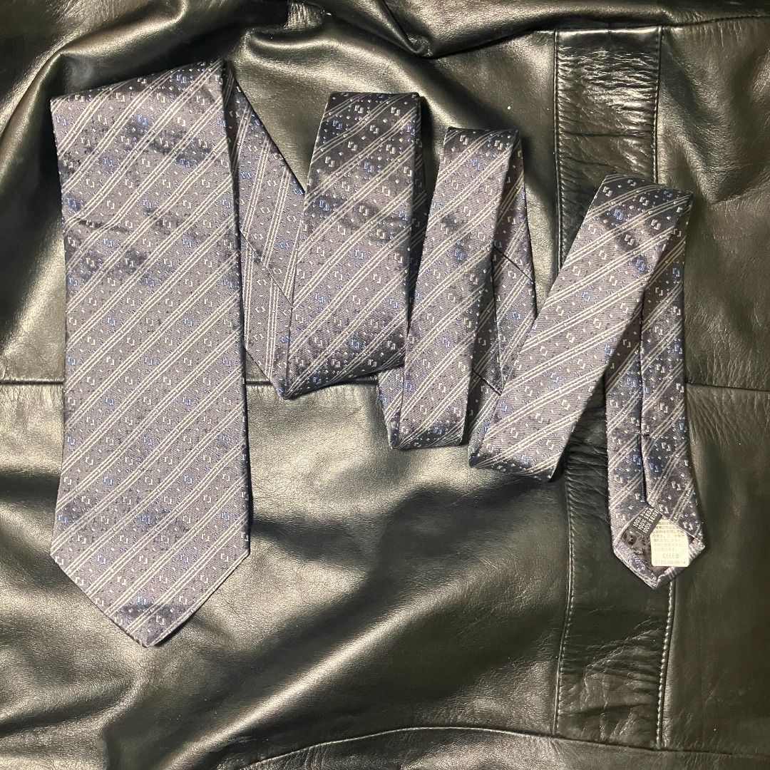 Renoma Paris 100% Silk Diagonal Stripe Necktie (Category: Ties) located in Manila. Submitted by nellyfrustrado (Listing ID 1470809937, Image 3). Description: tem Specifics: Brand: Renoma Paris (Features official brand label and matching patterned keeper loop). Material: 100% Silk (Labeled "100% SILK / 100% SOIE / 100% SETA"). Made in Italy. Colorway: Charcoal grey and slate blue base accented with diagonal woven stripes and subtle silver and roya