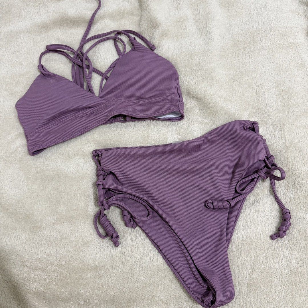 Ribbed Purple Bikini Set High-Waisted Halter (Category: Bikinis & Swimsuits) located in Manila. Submitted by kbm._. (Listing ID 1470929747, Image 1). Description: - Color: Mauve purple - Material: Stretchy ribbed fabric - Top: Halter style with multi-strap back design - Bottoms: High-waisted with cute side tie details - Condition: Clean and ready to wear.