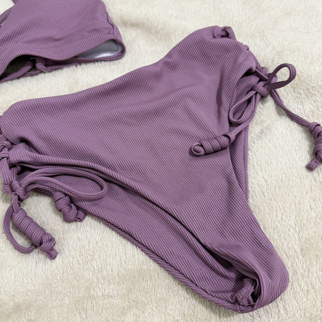 Ribbed Purple Bikini Set High-Waisted Halter (Category: Bikinis & Swimsuits) located in Manila. Submitted by kbm._. (Listing ID 1470929747, Image 3). Description: - Color: Mauve purple - Material: Stretchy ribbed fabric - Top: Halter style with multi-strap back design - Bottoms: High-waisted with cute side tie details - Condition: Clean and ready to wear.