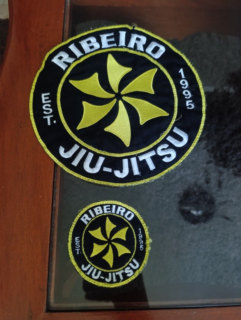 Ribeiro Jiu-Jitsu Embroidered Patches Set (Category: Activewear) located in Quezon City. Submitted by kuruma_13 (Listing ID 1470750724, Image 1). Description: - Authentic Ribeiro Jiu-Jitsu embroidered patches (Est. 1995) - Set includes 1 large round patch and 1 matching smaller patch - Striking black background with detailed yellow and white stitching - Clean white backing with secure finished borders - Perfect for customizing BJJ gis, gear bags,