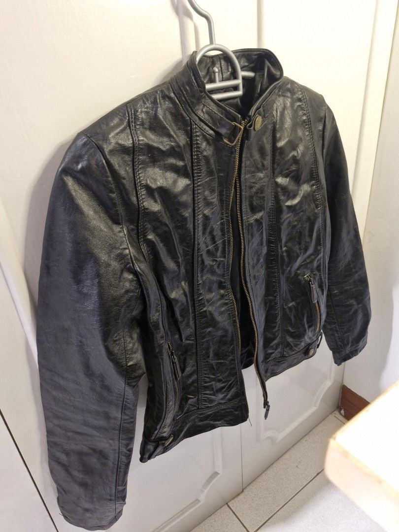 Ricardo Black Leather Jacket (Category: Coats, Jackets and Outerwear) located in Las Pinas. Submitted by n.ysabel (Listing ID 1470904828, Image 2). Description: - Brand: Ricardo - Style: Classic biker jacket - Material: Black leather with black fabric inner lining - Closure: Full front zipper with bronze-toned hardware - Details: Collar snap button and multiple zippered pockets on chest and sleeves - Condition: Great piece for cooler weather.