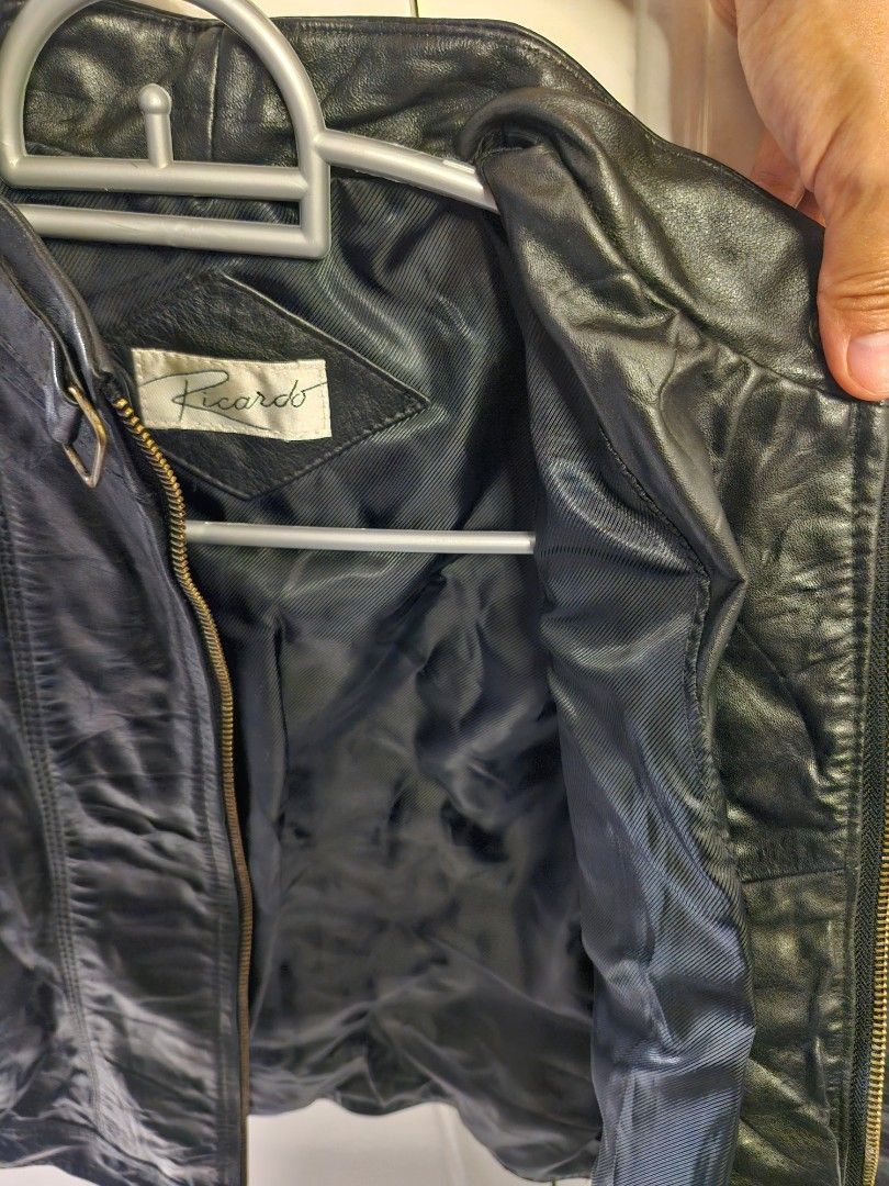 Ricardo Black Leather Jacket (Category: Coats, Jackets and Outerwear) located in Las Pinas. Submitted by n.ysabel (Listing ID 1470904828, Image 3). Description: - Brand: Ricardo - Style: Classic biker jacket - Material: Black leather with black fabric inner lining - Closure: Full front zipper with bronze-toned hardware - Details: Collar snap button and multiple zippered pockets on chest and sleeves - Condition: Great piece for cooler weather.