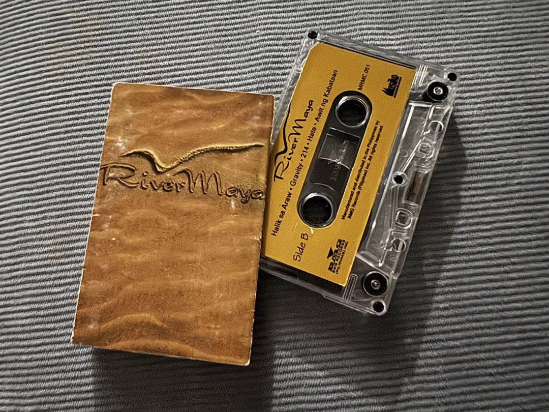 Rivermaya Cassette Tape (Category: CDs & DVDs) located in Cavite. Submitted by ms.cdjunkies (Listing ID 1470917806, Image 1). Description: - Artist/Album: Rivermaya - Label: BMG Records (Catalog No: MRMC 051) - Condition: Tested and working properly - Inclusions: Standard clear cassette case with textured brown album artwork sleeve - Key Tracks: Ulan, Halik sa Araw, Gravity, 214, Hate, Awit ng Kabataan and more… - Perfect for: OPM Pinoy rock coll