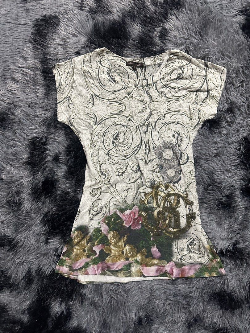 Roberto Cavalli Baroque Cherub Print Top Size S (Category: Shirts) located in Iba. Submitted by thriftcoyan (Listing ID 1470743555, Image 1). Description: - Brand: Roberto Cavalli - Size: Small - Design: Vintage Renaissance baroque scrollwork with cherubs and roses - Details: Front gold studded RC logo graphic and rhinestone floral appliques - Cut: Short cap sleeves with a classic round neckline - Material: Soft, stretchy, and comfortable fabric.