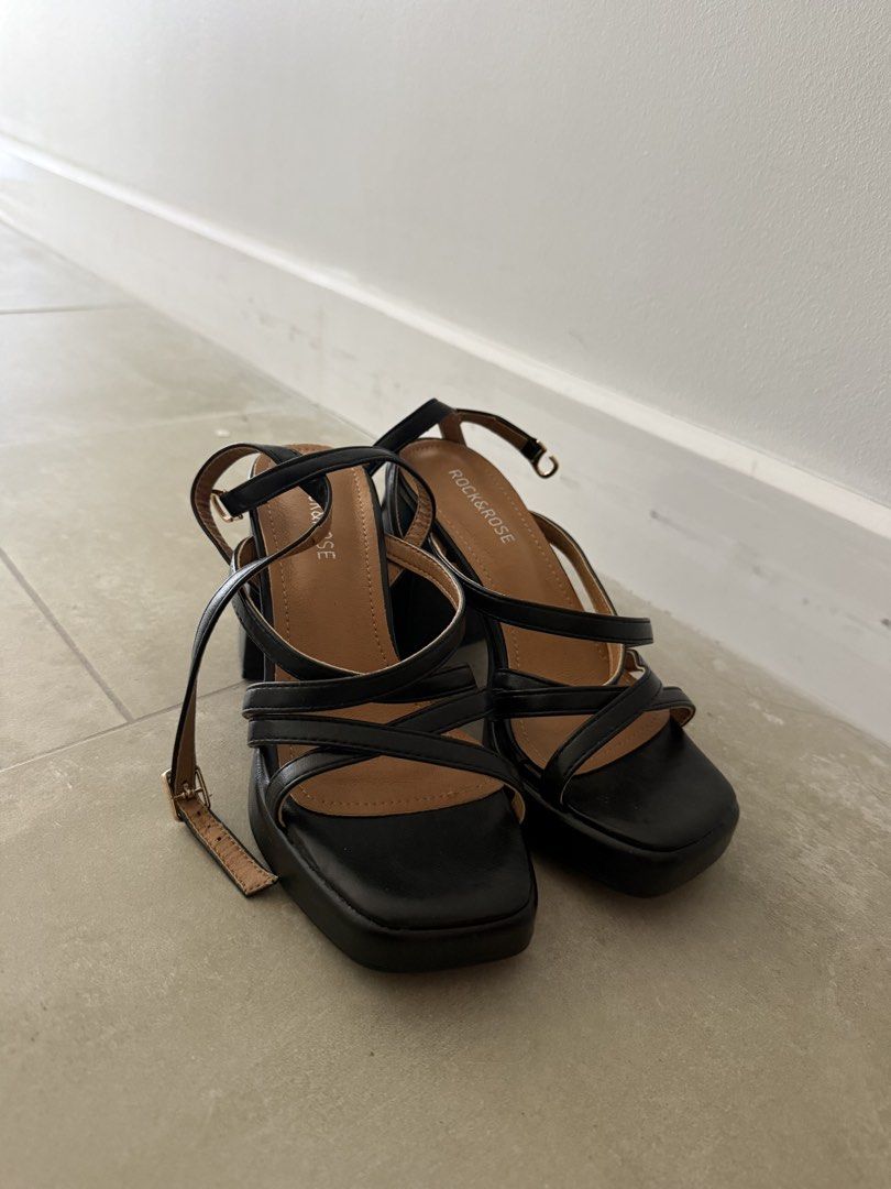 Rock & Rose Black Strappy Block Heels (Category: Heels) located in Makati City. Submitted by cagal.i0n (Listing ID 1470791900, Image 2). Description: - Brand: Rock & Rose - Color: Black with neutral tan inner sole - Style: Chunky block heel with square toe and strappy ankle wrap - Closure: Gold buckle closure - Comfort: Stable and easy to walk in - Occasion: Great for nights out or dressing up casual outfits Original price: 1,799.