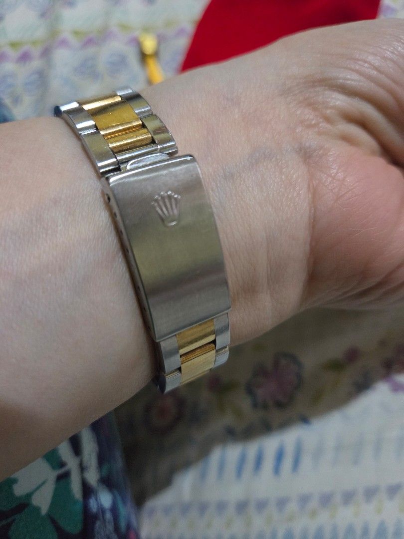Rolex Oyster Perpetual Two-Tone Watch (Category: Luxury Watches) located in Las Pinas. Submitted by swiftdragon_0c099a (Listing ID 1470798918, Image 3). Description: Authentic two-tone Rolex Oyster Perpetual. Features a silver dial with gold Arabic numerals, yellow gold bezel, and steel-and-gold bracelet. Shows normal signs of wear on the casing and links. Timeless and elegant piece ready to wear. 33mm ,very elegant in actual junior size .