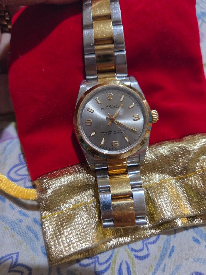 Rolex Oyster Perpetual Two-Tone Watch (Category: Luxury Watches) located in Las Pinas. Submitted by swiftdragon_0c099a (Listing ID 1470798918, Image 1). Description: Authentic two-tone Rolex Oyster Perpetual. Features a silver dial with gold Arabic numerals, yellow gold bezel, and steel-and-gold bracelet. Shows normal signs of wear on the casing and links. Timeless and elegant piece ready to wear. 33mm ,very elegant in actual junior size .