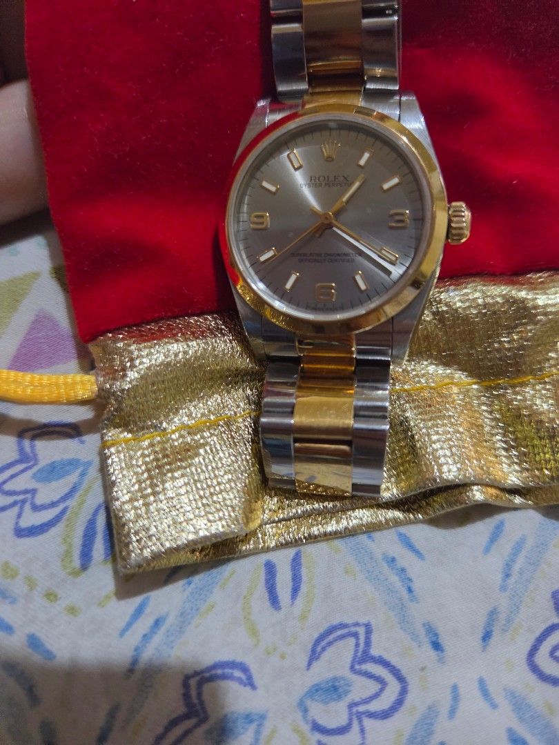 Rolex Oyster Perpetual Two-Tone Watch (Category: Luxury Watches) located in Las Pinas. Submitted by swiftdragon_0c099a (Listing ID 1470798918, Image 2). Description: Authentic two-tone Rolex Oyster Perpetual. Features a silver dial with gold Arabic numerals, yellow gold bezel, and steel-and-gold bracelet. Shows normal signs of wear on the casing and links. Timeless and elegant piece ready to wear. 33mm ,very elegant in actual junior size .