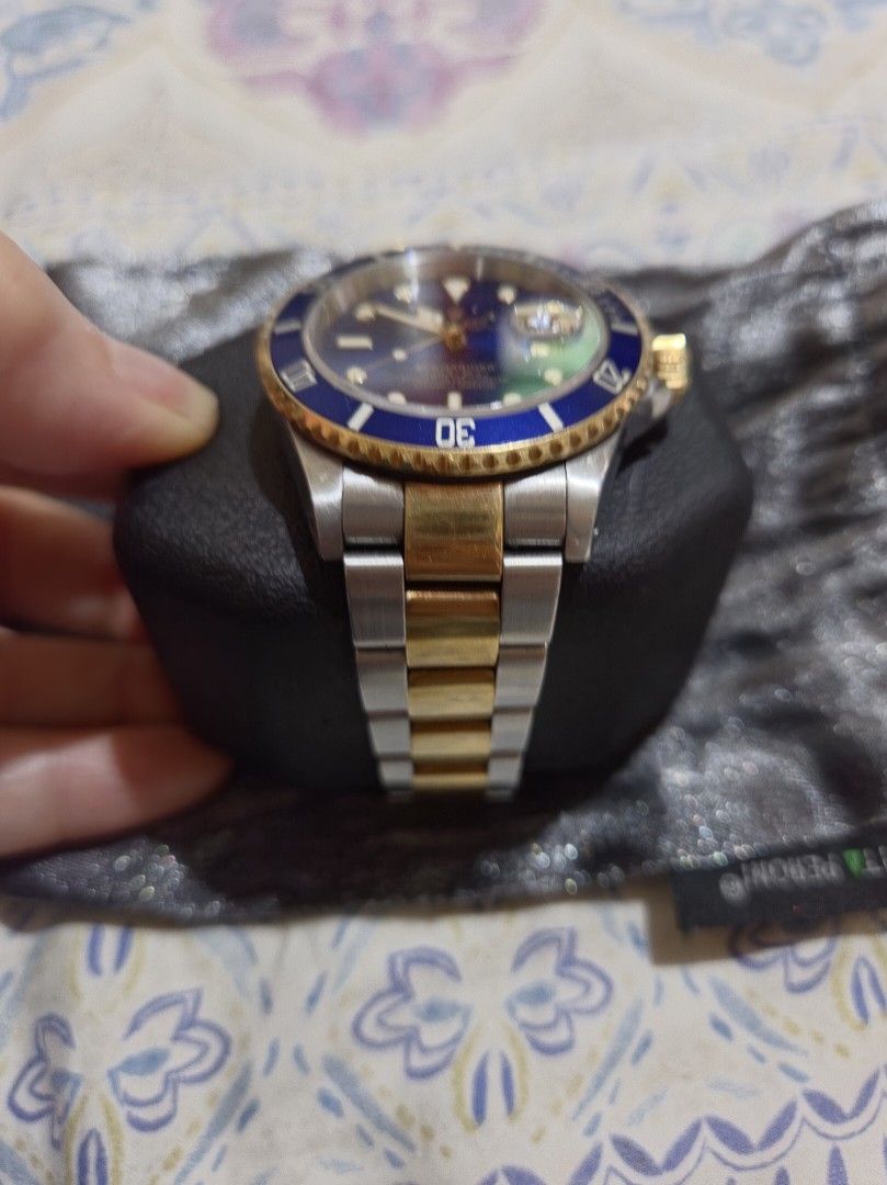 Rolex Submariner Blue Dial Two Tone Watch (Category: Men's Watches) located in Las Pinas. Submitted by swiftdragon_0c099a (Listing ID 1470796347, Image 2). Description: - Model: Rolex Submariner (Two-Tone Steel & Gold) - Dial/Bezel: Stunning blue dial with matching gold bezel - Features: Date window with cyclops lens, iconic Oyster bracelet - Condition: Runs great; shows normal, honest wear from everyday use on the case and band - Inclusions: Com