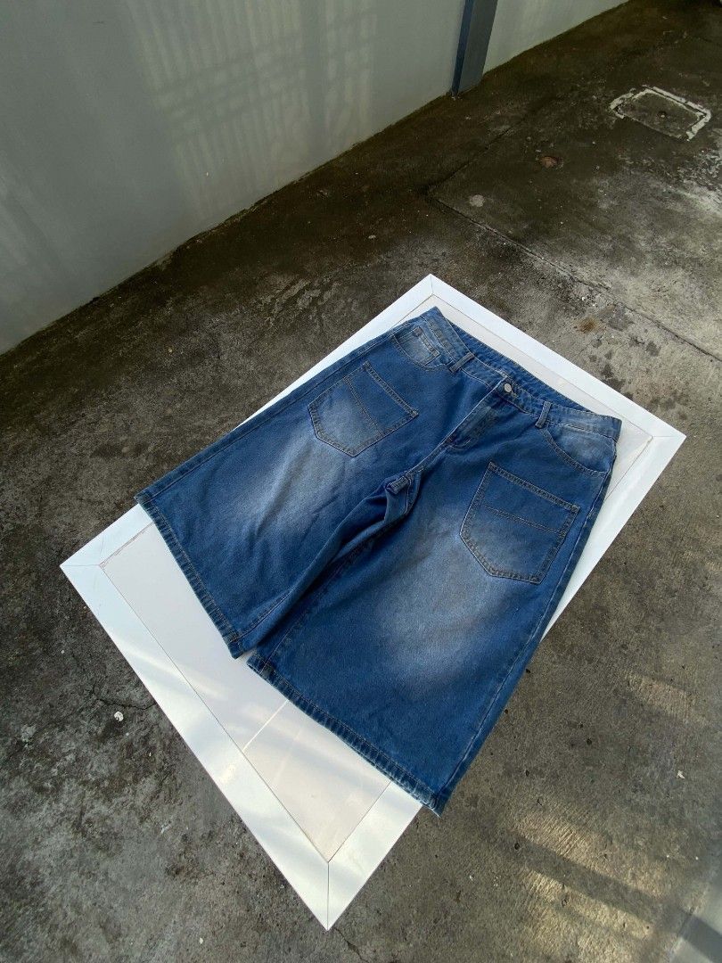 ROMWE Denim Jorts Size 34 Blue (Category: Shorts) located in Lucena. Submitted by whats-good (Listing ID 1470885693, Image 2). Description: - Brand: ROMWE - Size: 34 - Color: Classic medium blue wash with front whiskering - Fit: Baggy streetwear style - Features: Utility pockets on both legs, plus standard front and back pockets - Condition: Great style, easy to pair with tees and hoodies.