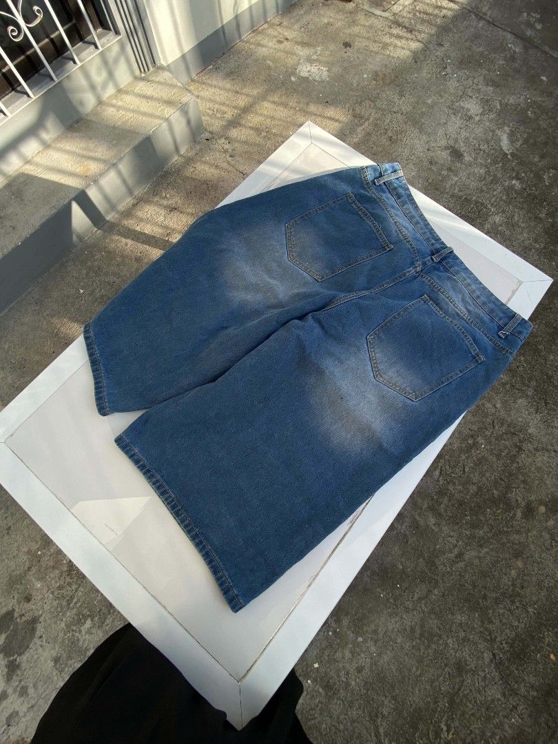 ROMWE Denim Jorts Size 34 Blue (Category: Shorts) located in Lucena. Submitted by whats-good (Listing ID 1470885693, Image 3). Description: - Brand: ROMWE - Size: 34 - Color: Classic medium blue wash with front whiskering - Fit: Baggy streetwear style - Features: Utility pockets on both legs, plus standard front and back pockets - Condition: Great style, easy to pair with tees and hoodies.
