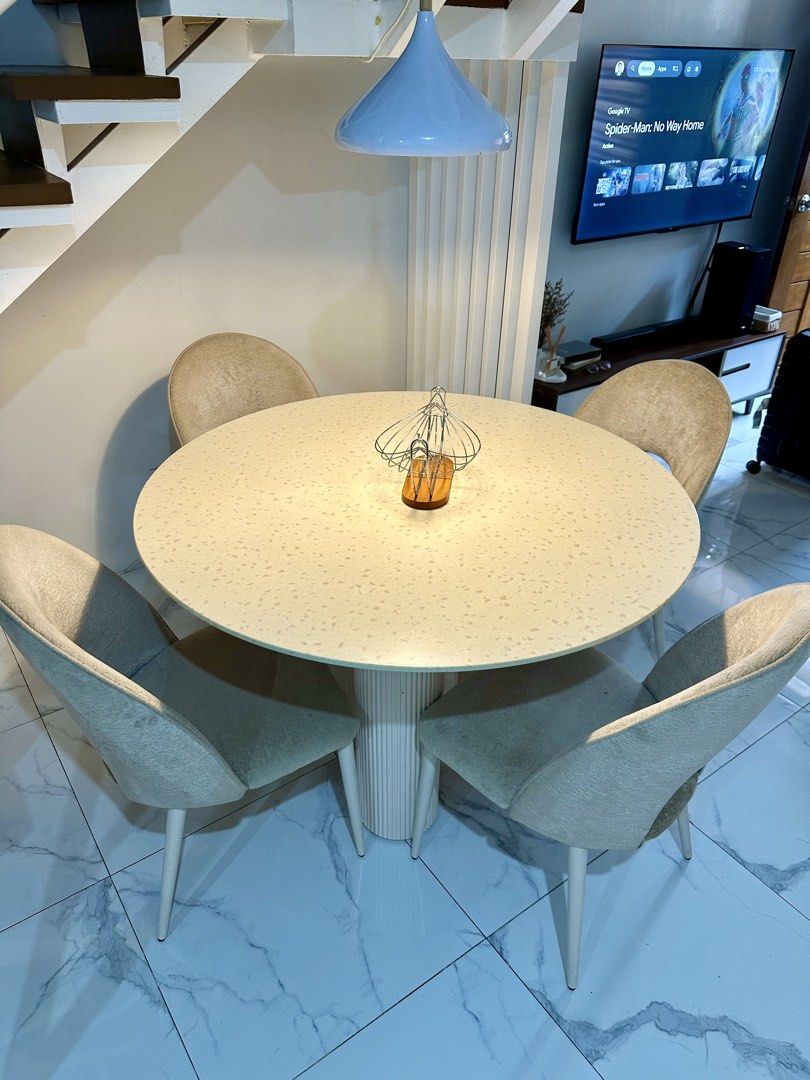 Round Dining Table With Four Upholstered Chairs (Category: Tables & Sets) located in Rizal. Submitted by mendellito (Listing ID 1470890143, Image 1). Description: Kinsley 4-Seater Round Dining Set Pre-loved dining set from Mandaue Foam, perfect for a modern and minimalist home. • 1 round dining table with fluted base • 4 beige upholstered dining chairs • Original price: ₱41,850 • Selling price: ₱25,000 • Condition: Well used 📍 Location: Town & C