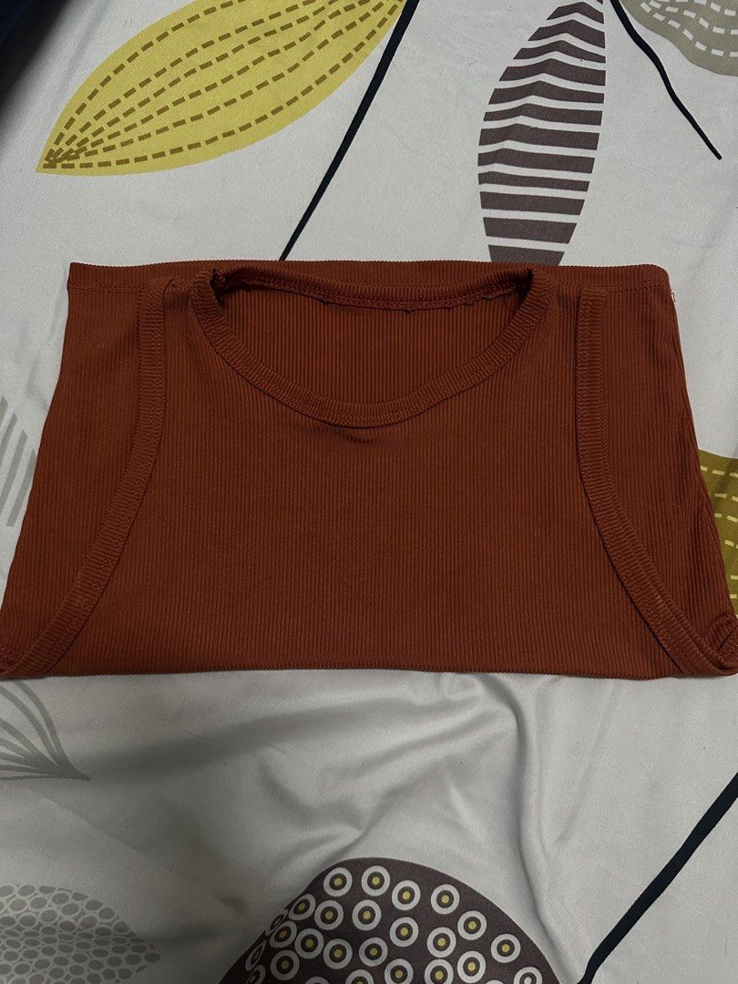 Rust Orange Ribbed Crop Tank Top (Category: Sleeveless) located in Manila. Submitted by francellin (Listing ID 1470765539, Image 2). Description: - Color: Rust Orange - Fabric: Stretchy ribbed knit - Fit: Cropped, comfortable fit - Design: Crew neckline, sleeveless - Styling: Perfect to pair with high-waisted jeans or skirts - Condition: Clean, EUC, ready to wear.