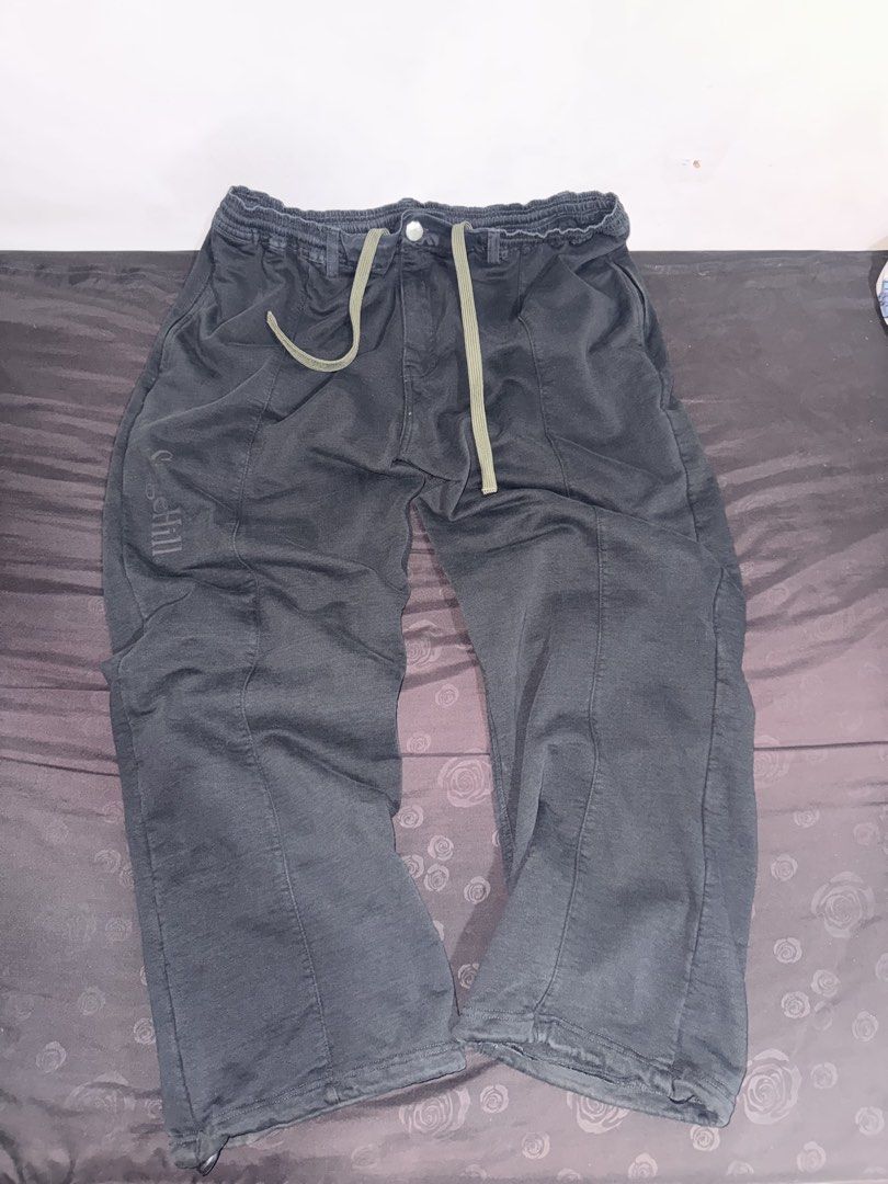 SageHill Dark Grey Casual Pants with Drawstring (Category: Trousers) located in Manila. Submitted by keenfish_8a86af (Listing ID 1470914692, Image 1). Description: - Brand: SageHill - Color: Dark grey with a slightly washed finish - Fit: Relaxed fit - Waistband: Elastic with a contrasting green drawstring - Details: Front vertical seam on each leg and small printed brand text near the right lower pocket - Condition: Clean, no obvious flaws.