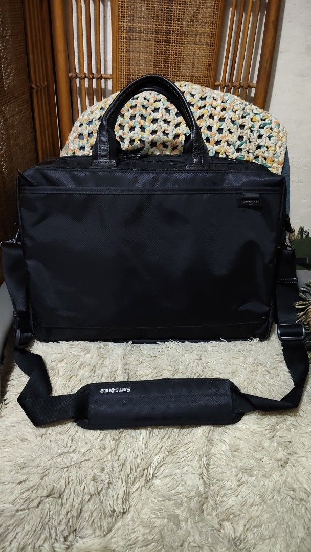 Samsonite Black Laptop Briefcase Shoulder Bag (Category: Briefcases) located in Cebu City. Submitted by lumaynojes00490 (Listing ID 1470829165, Image 2). Description: - Brand: Samsonite - Color: Classic Black - Material: Durable nylon with genuine leather handles - Storage: Spacious zippered main compartments plus a front pocket for quick access - Comfort: Includes an adjustable shoulder strap with a branded padded grip - Condition: Clean exterio