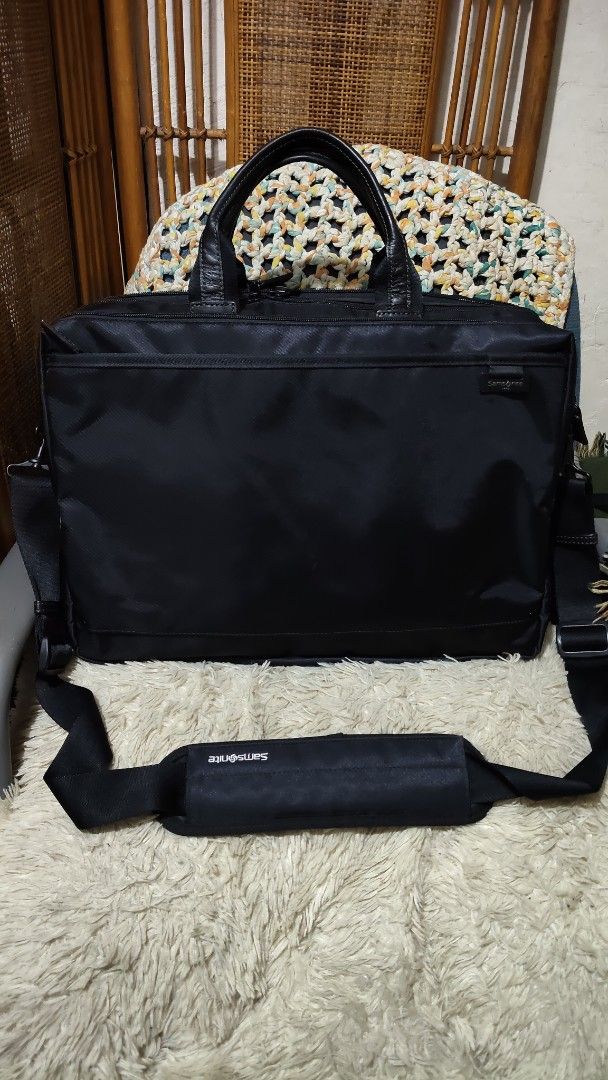 Samsonite Black Laptop Briefcase Shoulder Bag (Category: Briefcases) located in Cebu City. Submitted by lumaynojes00490 (Listing ID 1470829165, Image 3). Description: - Brand: Samsonite - Color: Classic Black - Material: Durable nylon with genuine leather handles - Storage: Spacious zippered main compartments plus a front pocket for quick access - Comfort: Includes an adjustable shoulder strap with a branded padded grip - Condition: Clean exterio