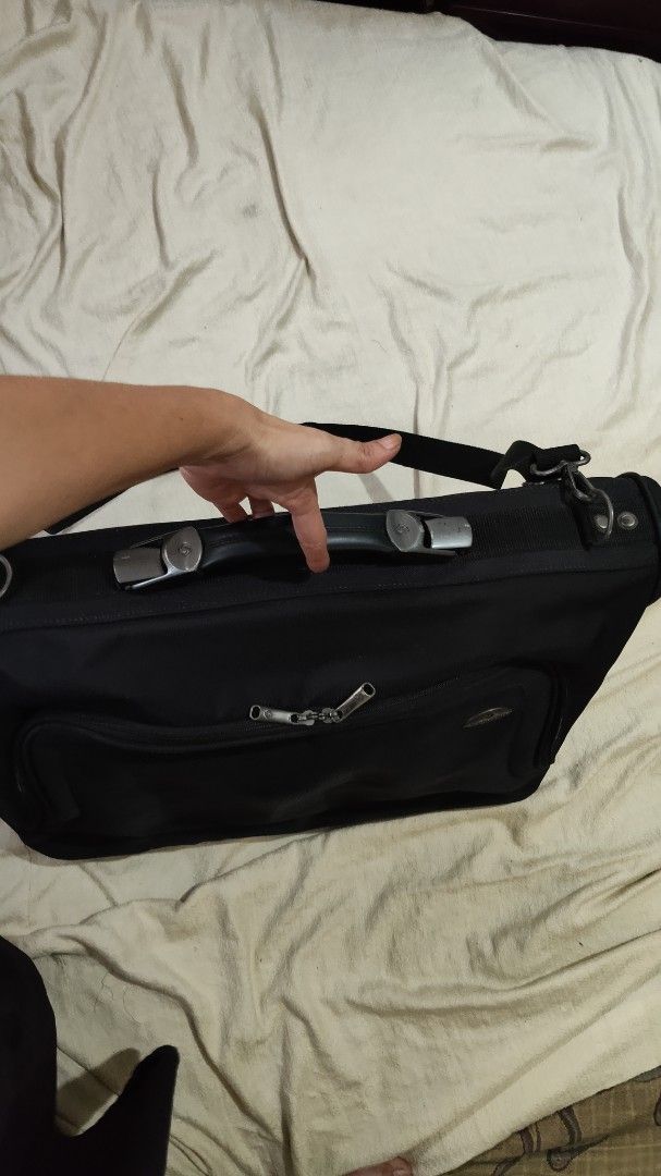 Samsonite Black Travel Garment Bag with Shoulder Strap (Category: Briefcases) located in Cebu City. Submitted by lumaynojes00490 (Listing ID 1470828614, Image 3). Description: - Brand: Samsonite - Color: Black - Durable fabric construction - Sturdy top handle & adjustable shoulder strap - Multiple zippered exterior pockets for easy organization - Protective feet on the bottom edge - Solid build, ready for your next trip.