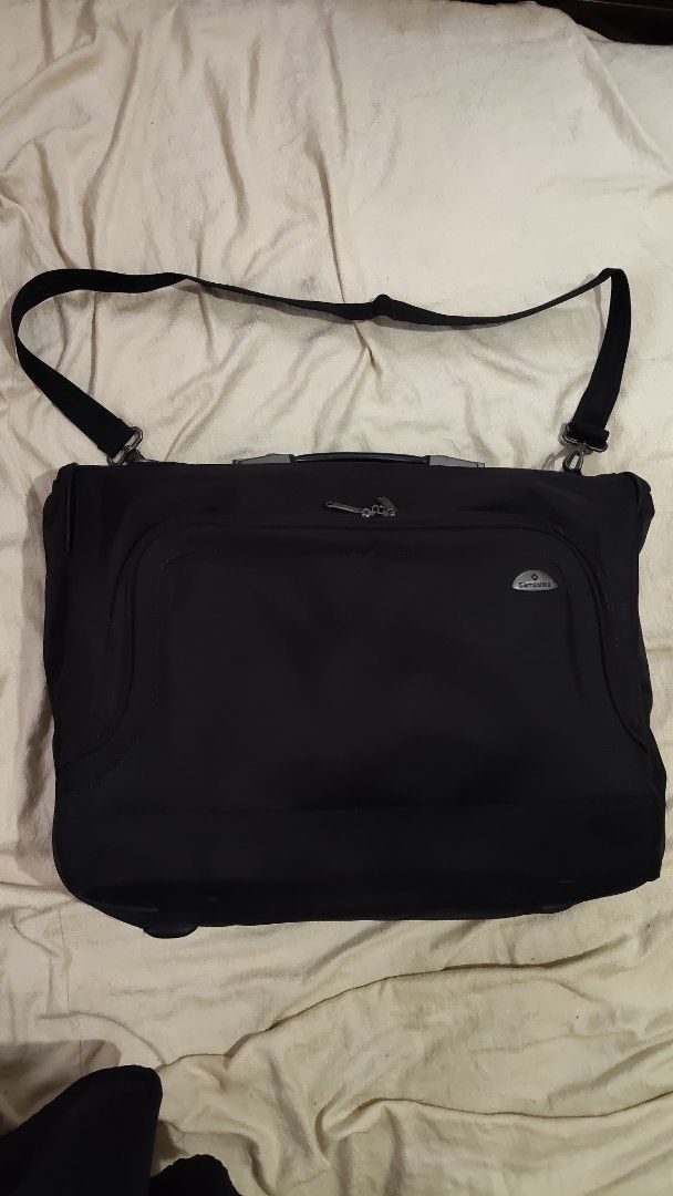 Samsonite Black Travel Garment Bag with Shoulder Strap (Category: Briefcases) located in Cebu City. Submitted by lumaynojes00490 (Listing ID 1470828614, Image 2). Description: - Brand: Samsonite - Color: Black - Durable fabric construction - Sturdy top handle & adjustable shoulder strap - Multiple zippered exterior pockets for easy organization - Protective feet on the bottom edge - Solid build, ready for your next trip.