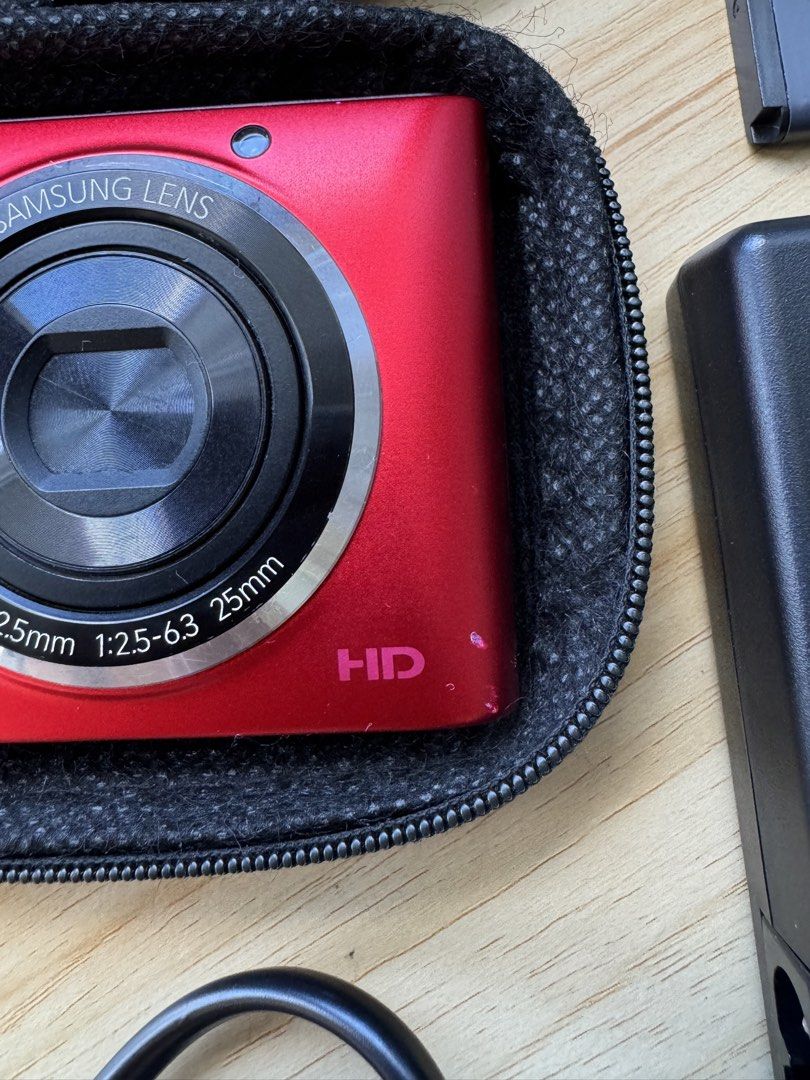 Samsung ST72 Digital Camera Bundle with Charger and Case (Category: Cameras) located in Zamboanga. Submitted by aiza.declutters (Listing ID 1470781505, Image 2). Description: Samsung ST72 Digital Camera (Red) ❗️Negotiable❗️ - Cosmetic Condition: 6/10 *minor scratches & dents - Inclusions: * Samsung BP70A rechargeable battery * SBC-70A charger with power cord * case & cleaning cloth - Issues: *cracked lower part (does NOT affect function or output