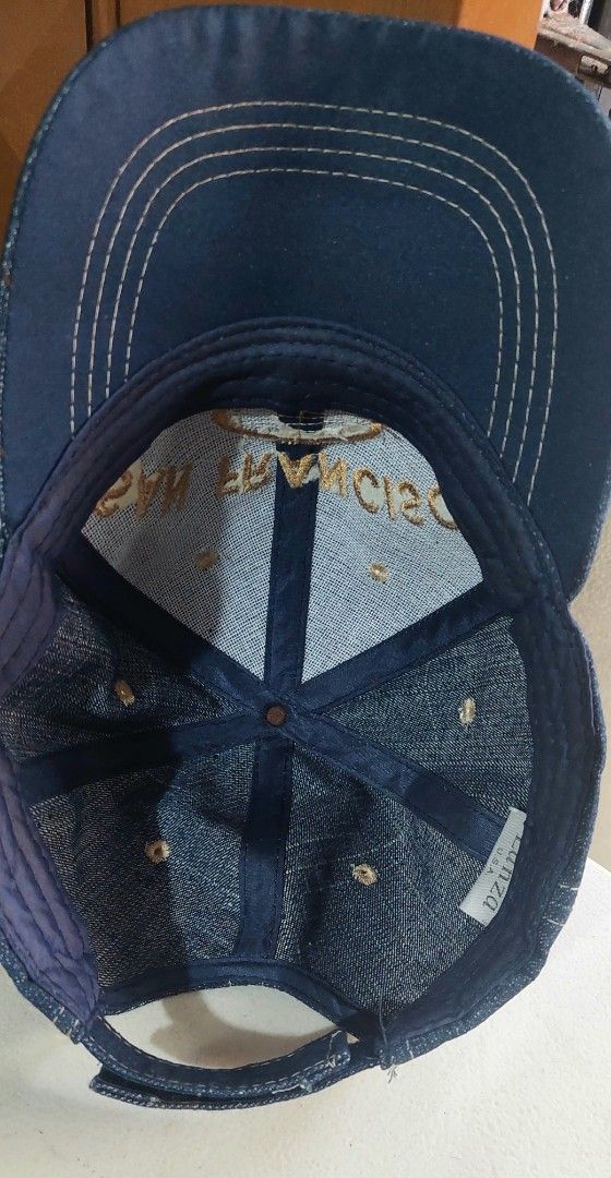 San Francisco Denim Baseball Cap (Category: Caps & Hats) located in Baguio. Submitted by ayra1523 (Listing ID 1470768707, Image 3). Description: - Brand: Lanza U.S.A. - Material: Dark denim with contrast stitching - Design: San Francisco embroidery on front and brim - Detail: Oval leather patch with stamped SF logo - Fit: Adjustable strap at the back for a custom fit - Condition: Structured crown with clean white interior lining and original bran