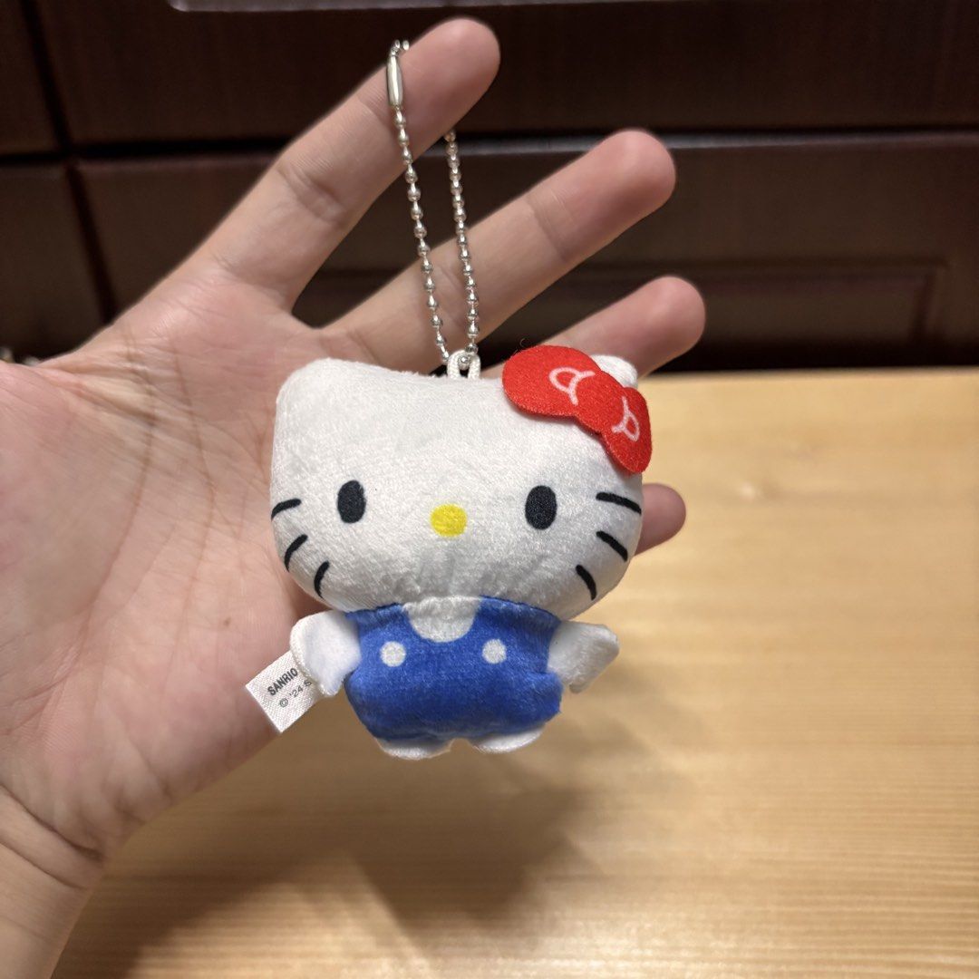 Sanrio Hello Kitty Blue Overalls Plush Keychain '24 (Category: Plushies & Soft Toys) located in Manila. Submitted by nero.ph (Listing ID 1470822945, Image 1). Description: - Authentic Sanrio '24 Kitty plush keychain - Features cute blue polka dot overalls and signature red bow - Equipped with a sturdy metal ball chain for easy attachment - Compact and handy for bags, keys, or lanyards.