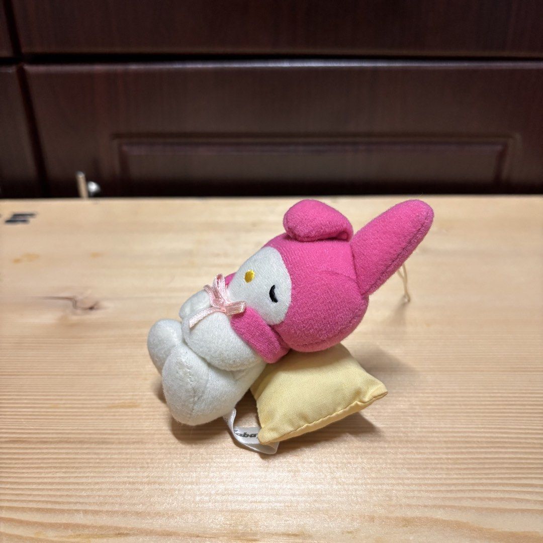 Sanrio My Melody Sleeping Plush Keychain (Category: Plushies & Soft Toys) located in Manila. Submitted by nero.ph (Listing ID 1470823191, Image 2). Description: - Authentic Sanrio My Melody plush mascot hanging charm - Features My Melody in a pink hood and white body resting on a tiny yellow pillow with a pink bow - Equipped with a white hanging loop string for bags, keys, or lanyards - Official vintage tag reads Sanrio copyright 1976, 2000, Toky