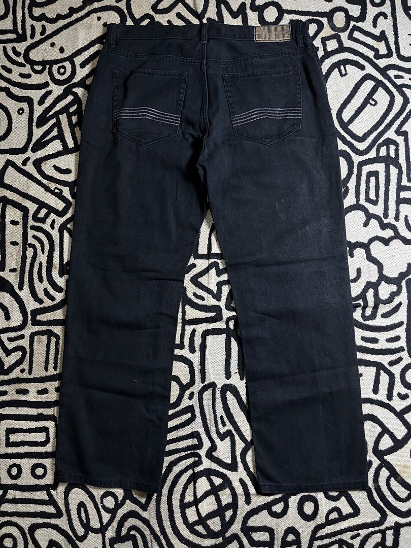 Sean John Black Denim Jeans (Category: Jeans) located in Silang. Submitted by yusthrift (Listing ID 1470825576, Image 1). Description: - Brand: Sean John - Color/Wash: Dark wash black denim with visible texture - Fit: Relaxed fit style, Y2K streetwear vibe - Details: Detailed stitching on back pockets, branded patch, and stitched label on coin pocket - Features: Button closure and belt loops - Condition: Solid construction, well-maintainedt 19 in