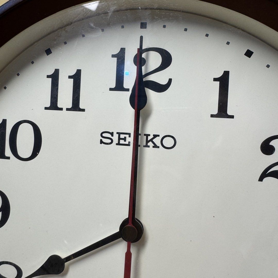 SEIKO Radio-Controlled Wall Clock (Model: KX223B) (Category: Clocks) located in Pasig City. Submitted by msjazzylad (Listing ID 1470928446, Image 3). Description: Product Overview Brand: SEIKO Model: KX223B Type: Radio-Controlled / Wave-Calibrated Quartz Wall Clock (Radio Wave / Radio Control) Design: Dark brown / wooden-tone round frame with retro classic font numbers, off-white dial, at red second hand. Dimensions: Diameter: Approx. 11 inches (