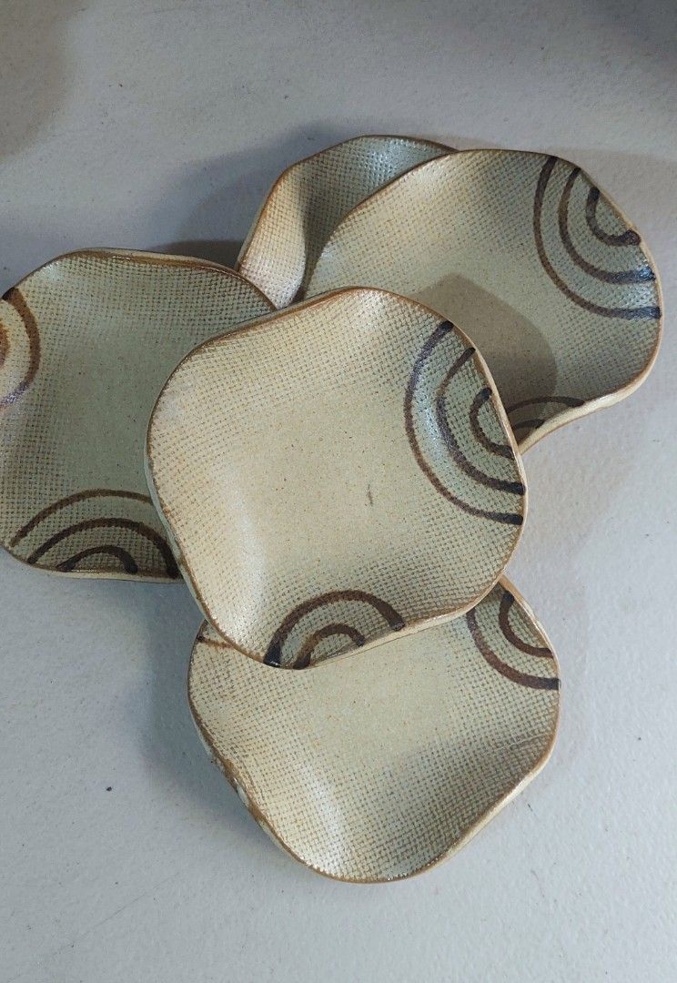 Set of 5 Ceramic Small Plates (Category: Dinnerware & Cutlery) located in Baguio. Submitted by ayra1523 (Listing ID 1470796692, Image 1). Description: - Set of 5 charming small ceramic plates - Features a unique wavy rim, textured grid pattern, and brown swirl design - Beautiful earthy cream and brown tones - Space-saving stackable shape - Versatile use: great for small snacks, dipping sauces, or dainty jewelry trays - Condition: Brand new / Exce