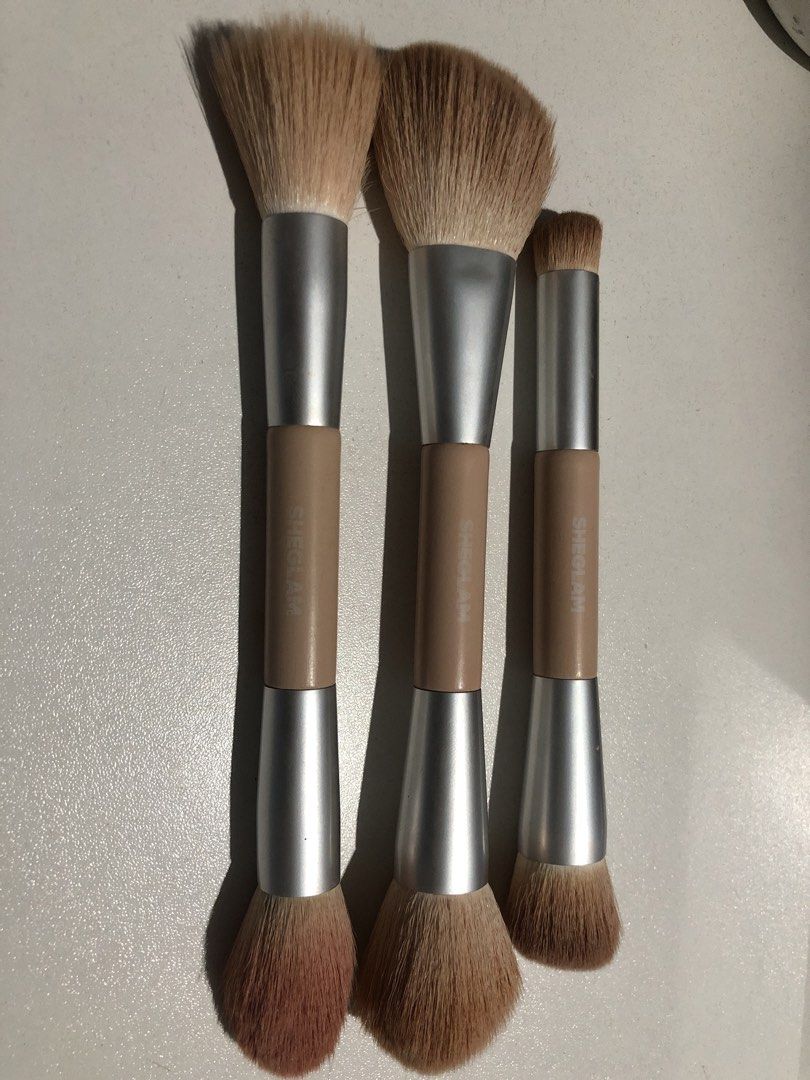 SHEGLAM Double-Sided Makeup Brushes Set of 3 (Category: Makeup) located in Manila. Submitted by camron08 (Listing ID 1470882535, Image 1). Description: - Brand: SHEGLAM - Quantity: Set of 3 double-ended brushes - Design: Beige handles with silver metal ferrules - Bristles: Soft synthetic fibers in versatile shapes - Best for: Face and powder application - Condition: Clean and ready to use.