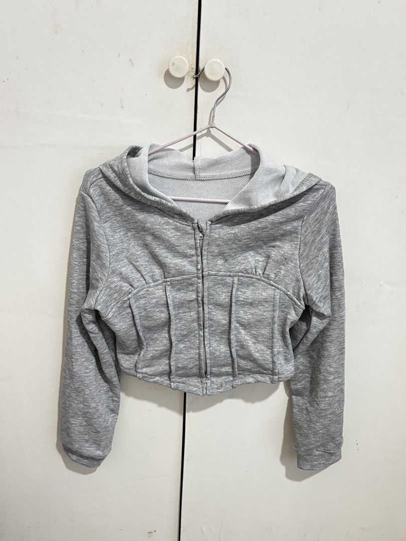 Shein Grey Corset Hoodie Cropped Jacket (Category: Coats, Jackets and Outerwear) located in Manila. Submitted by dianafayesimbre (Listing ID 1470814893, Image 3). Description: - Grey zip-up hoodie with front zipper closure - Trendy corset-style waist with a cropped fit - Long sleeves and attached hood - Soft and cozy fleece lining inside - Size: Teen 13Y on tag but can fit xxs to small - Great basic piece for everyday layering.