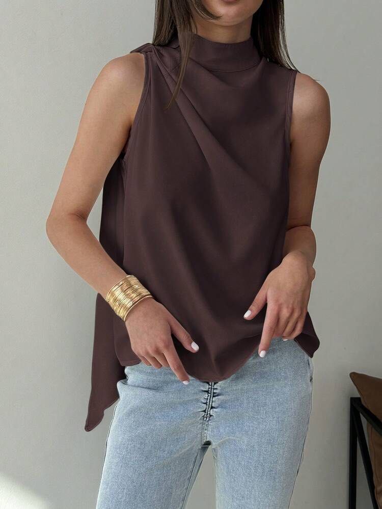 Shein Halter Top Brown XXS (Category: Sleeveless) located in Manila. Submitted by areiei (Listing ID 1470350611, Image 3). Description: - Brand: Shein - Color: Purplish Brown - Size: XXS - Style: Halter top with mock neck and draped side tie detail - Sleeveless and lightweight fabric - Perfect for casual outings, layering, or pairing with high-waisted bottoms SF Shouldered by Buyer.