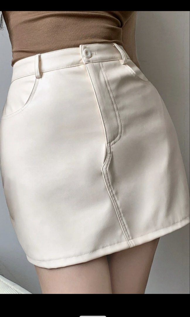 SHEIN PU Leather Mini Skirt Beige (Category: Skirts) located in Manila. Submitted by shoppingcentermanila (Listing ID 1470864646, Image 3). Description: USED ONCE Bought at ₱540. Selling low! Best fits 26-27 - Style: PU leather mini skirt / short pencil skirt - Color: Versatile beige (Solid) - Closure: Button and zip - Material: PU leather - Season: Perfect for autumn and year-round styling.