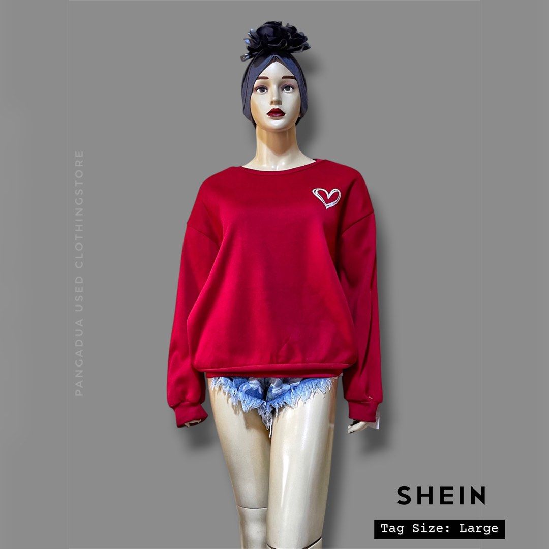 SHEIN Red Heart Sweatshirt Large (Category: Coats, Jackets and Outerwear) located in Naga. Submitted by 2ndusedclothingstore (Listing ID 1470848538, Image 1). Description: - Brand: SHEIN - Color: Bright red with a small white heart outline on the chest - Size: Large - Material: 100% polyester - Lining: Soft fleece inside for added warmth and comfort - Fit: Relaxed, casual fit - Styling: Perfect to pair with denim shorts or jeans for daily wear.