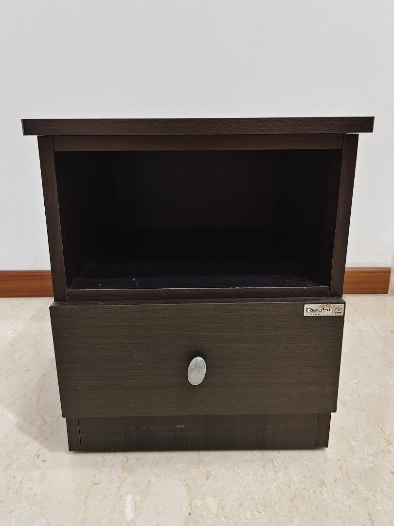 Side Table (Category: Tables & Sets) located in Singapore. Submitted by blindmaster (Listing ID 1470801978, Image 2). Description: - Type: Dark wood bedside table - Storage: Open top with 1 sliding pull-out drawer - Design: Solid dark brown finish with visible wood grain and silver-toned oval knob (discoloration) - Size: Compact, ideal for bedrooms or study rooms - Dimensions, L: 34cm x W: 38cm x H: 41.5cm - Item small enough to fit into the car 