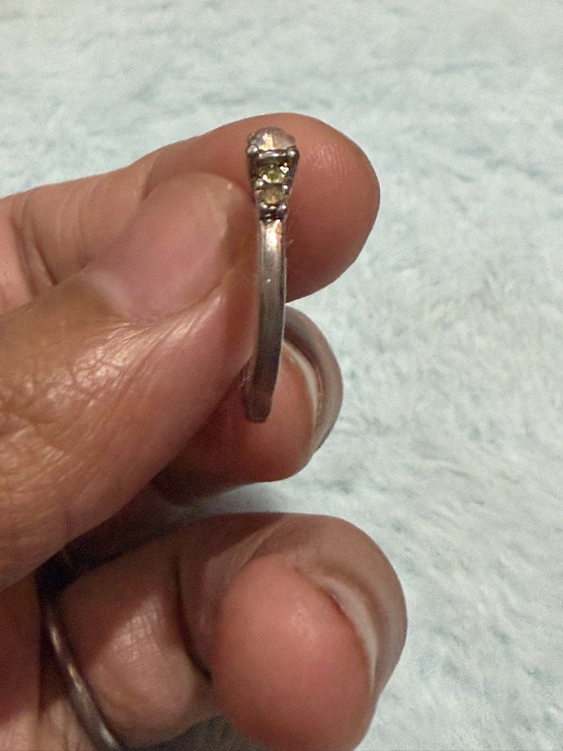 Silver multi-stone ring with central iridescent crystal but with missing crystal Size 5.5 (Category: Rings) located in Mandaue City. Submitted by chuchi152615 (Listing ID 1470916208, Image 3). Description: Issue: missing stones - Silver-tone band with a striking central iridescent gemstone - Accented with smaller green and dark purple crystals in a classic multi-stone design - Comfortable fit for all-day wear - Versatile accessory, perfect for da