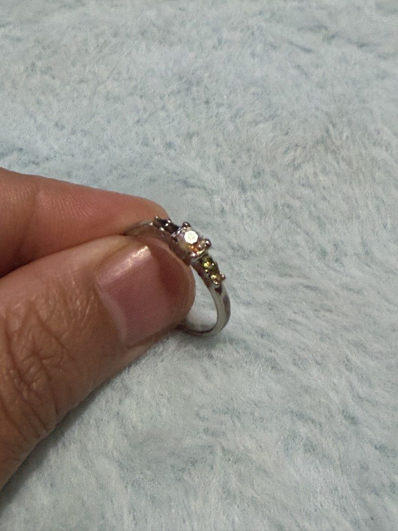 Silver multi-stone ring with central iridescent crystal but with missing crystal Size 5.5 (Category: Rings) located in Mandaue City. Submitted by chuchi152615 (Listing ID 1470916208, Image 2). Description: Issue: missing stones - Silver-tone band with a striking central iridescent gemstone - Accented with smaller green and dark purple crystals in a classic multi-stone design - Comfortable fit for all-day wear - Versatile accessory, perfect for da